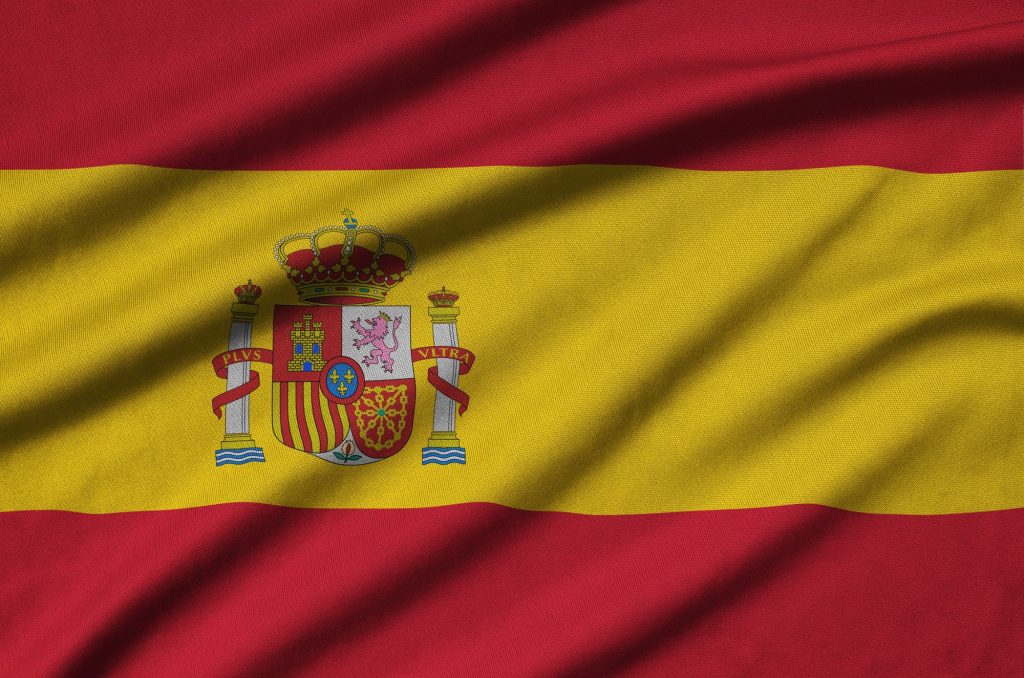 Spain flag is depicted on a sports cloth fabric with many folds. Sport team waving banner